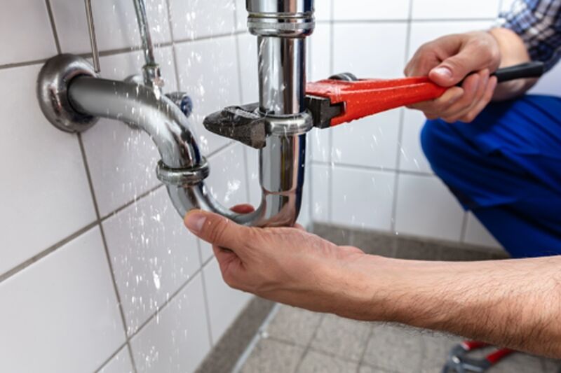 Plumber Repairing Sink Pipe Leakage fixing a drain